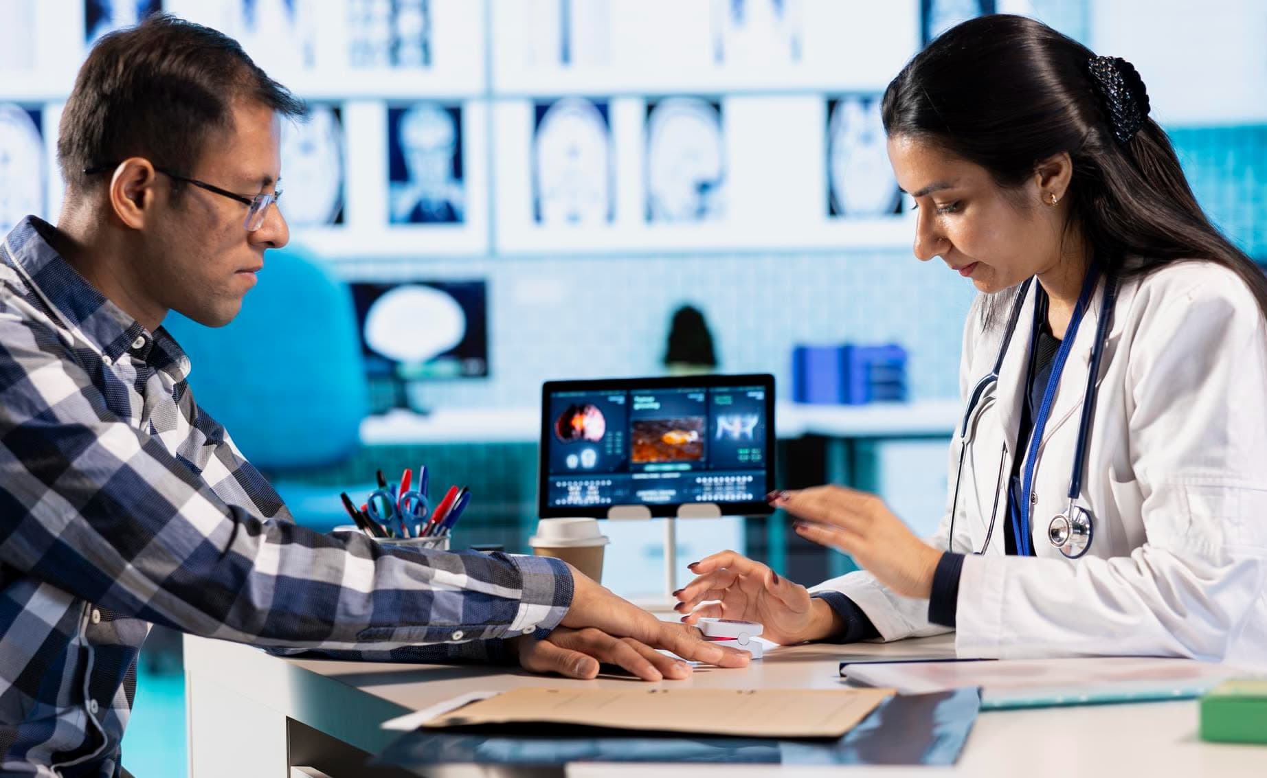 A clinician going through results with a patient at a screen.